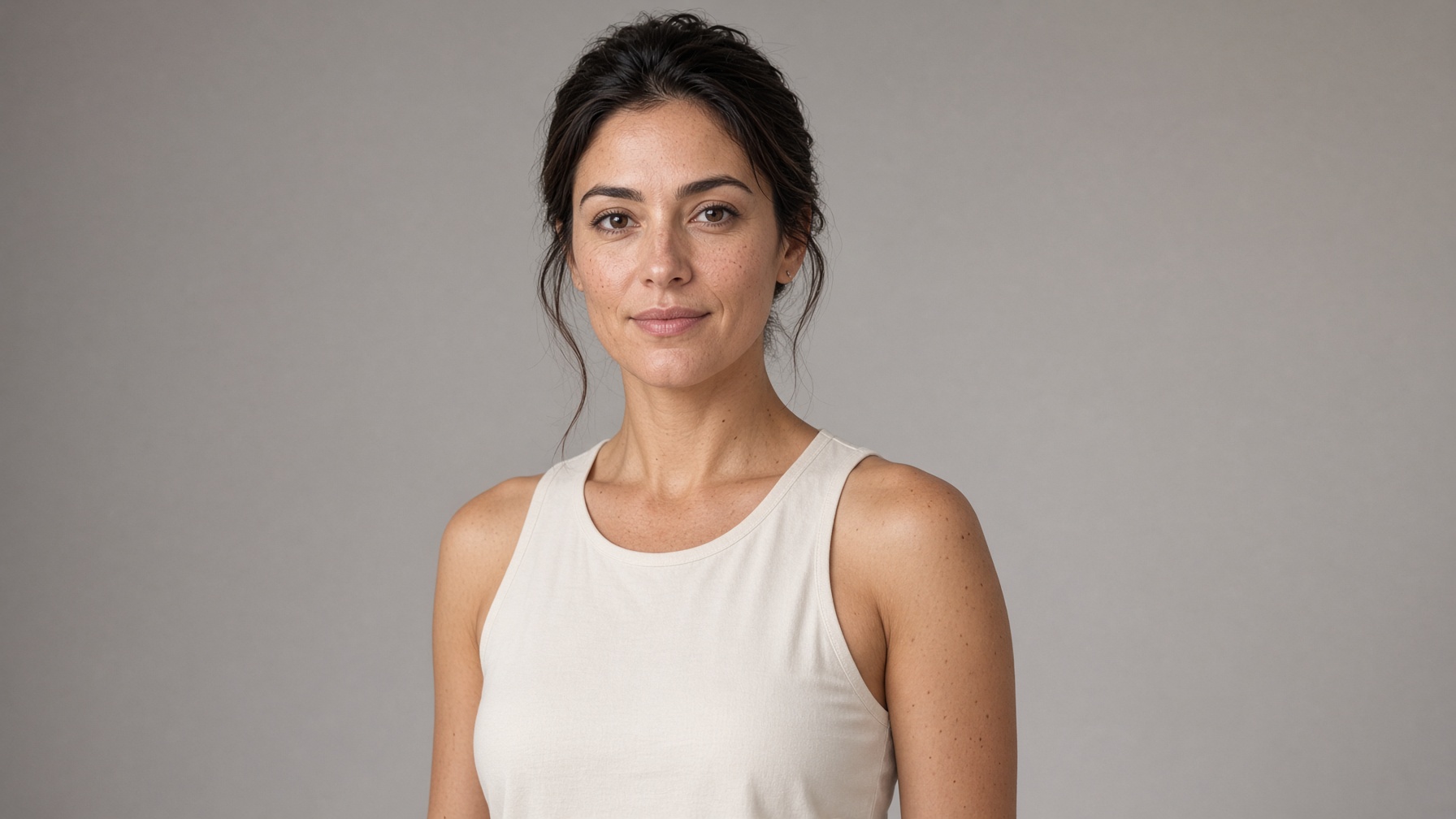Campaign still of a woman in a plain studio
